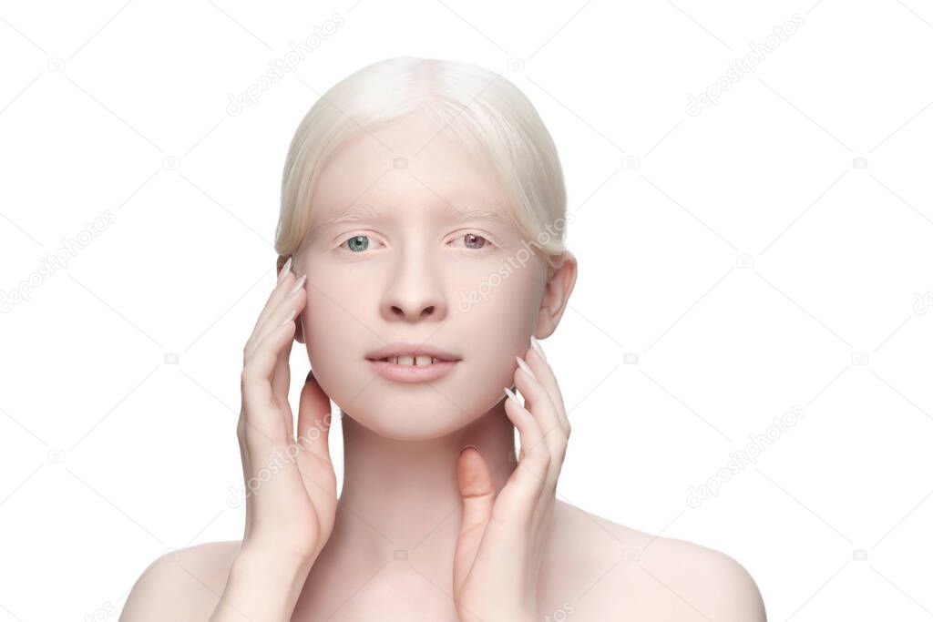 Beautiful albino woman with heterochromia isolated on white studio background