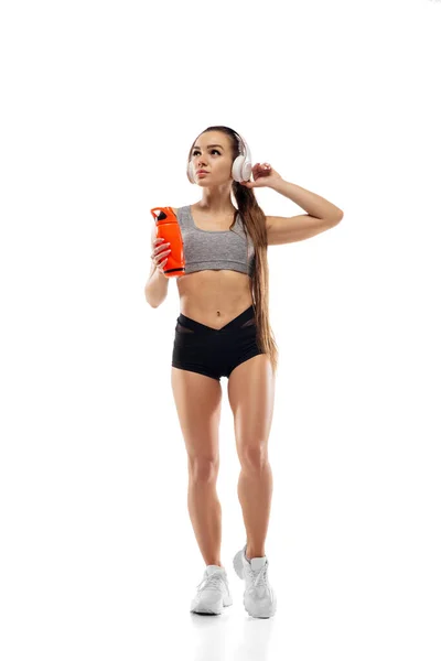Caucasian professional female runner, athlete training isolated on white studio background. Copyspace for ad. — Stock Photo, Image
