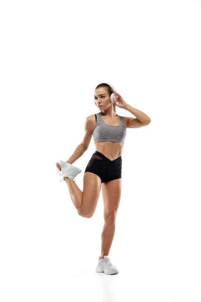 Caucasian professional female runner, athlete training isolated on white studio background. Copyspace for ad. — Stock Photo, Image