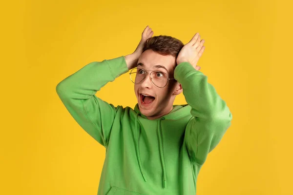 Portrait of young caucasian man isolated on yellow studio background — Stock Photo, Image