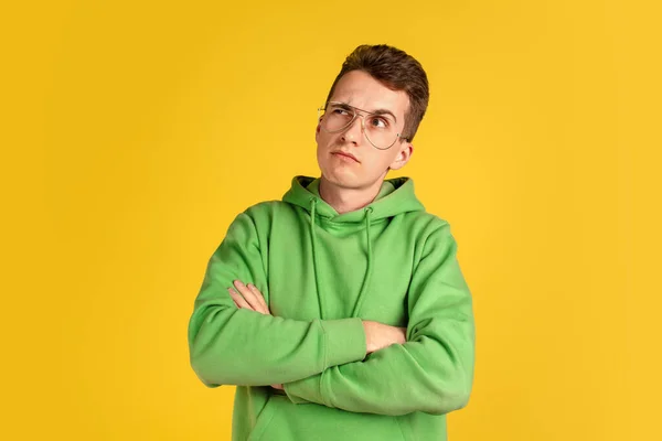 Portrait of young caucasian man isolated on yellow studio background — Stock Photo, Image