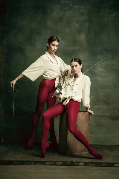 Two young female ballet dancers like duelists with swords. Ballet and contemporary choreography concept. Creative art photo. — Stock Photo, Image