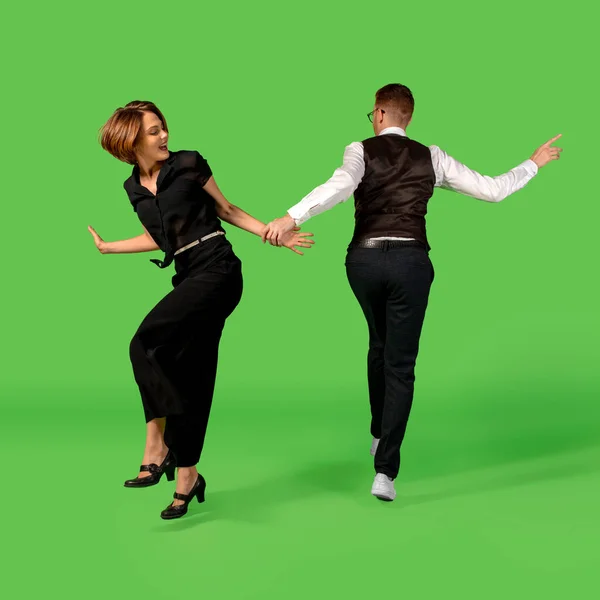 Ouderwetse jonge vrouw dansen geïsoleerd op groene achtergrond — Stockfoto