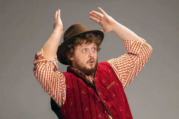 Happy smiling man dressed in traditional Austrian or Bavarian costume gesturing isolated on grey studio background — Stock Photo, Image