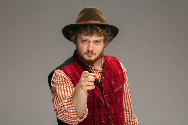 Happy smiling man dressed in traditional Austrian or Bavarian costume gesturing isolated on grey studio background — Stock Photo, Image