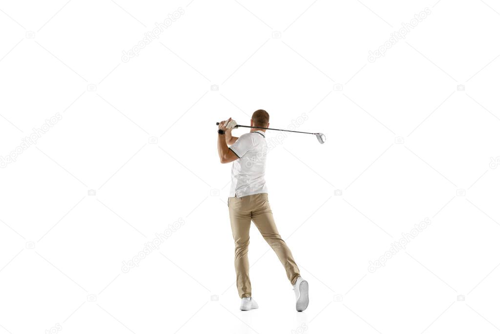 Golf player in a white shirt taking a swing isolated on white studio background
