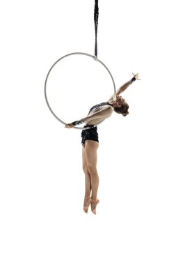 Young female acrobat, circus athlete isolated on white studio background. Training perfect balanced in flight