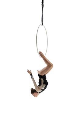 Young female acrobat, circus athlete isolated on white studio background. Training perfect balanced in flight