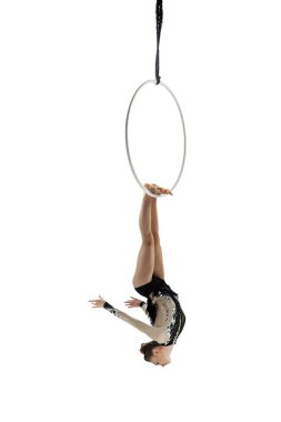 Young female acrobat, circus athlete isolated on white studio background. Training perfect balanced in flight