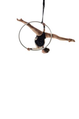Young female acrobat, circus athlete isolated on white studio background. Training perfect balanced in flight