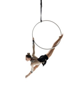 Young female acrobat, circus athlete isolated on white studio background. Training perfect balanced in flight