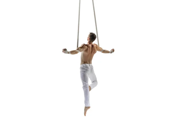 Young male acrobat, circus athlete isolated on white studio background. Training perfect balanced in flight — Photo