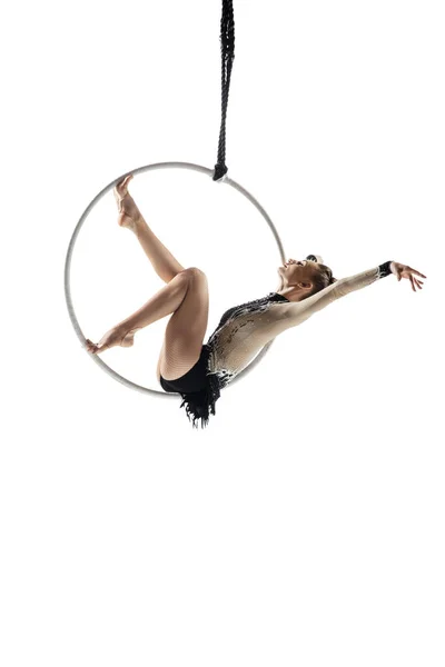 Young female acrobat, circus athlete isolated on white studio background. Training perfect balanced in flight — Photo