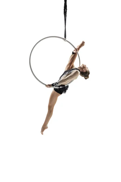 Young female acrobat, circus athlete isolated on white studio background. Training perfect balanced in flight — ストック写真