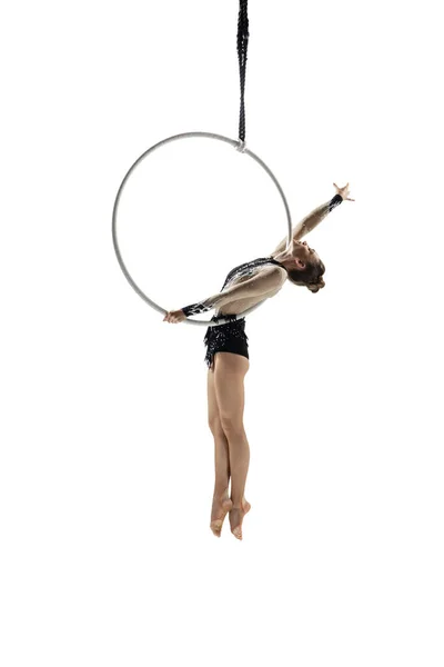 Young female acrobat, circus athlete isolated on white studio background. Training perfect balanced in flight — Photo