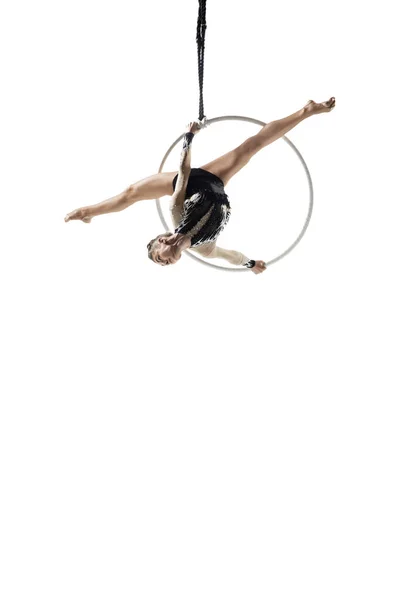 Young female acrobat, circus athlete isolated on white studio background. Training perfect balanced in flight — Stockfoto