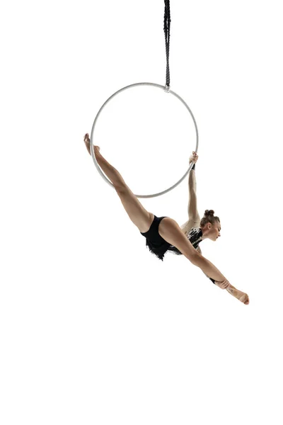 Young female acrobat, circus athlete isolated on white studio background. Training perfect balanced in flight — ストック写真