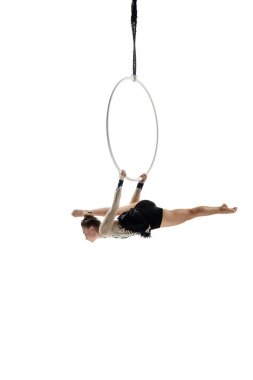Young female acrobat, circus athlete isolated on white studio background. Training perfect balanced in flight
