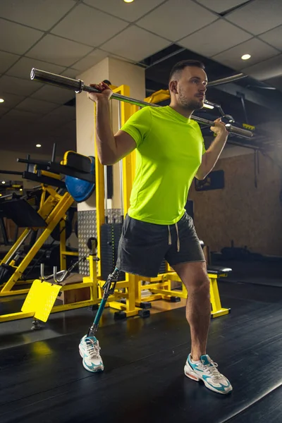 Disabled man training in the gym of rehabilitation center