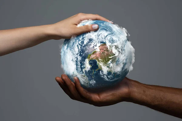 Two hands holding planet Earth, close up. Environment save, taking care of nature and ecology, supporting hands concept — Stock Photo, Image