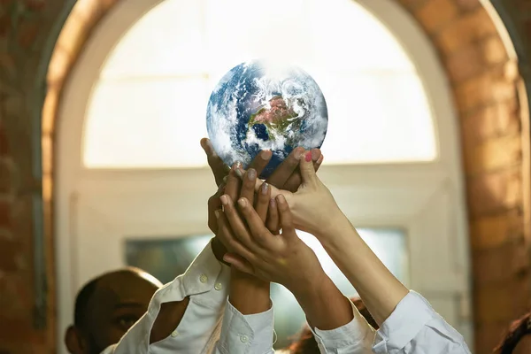 Doctors holding a world globe in hands, concept of world health, supporting — Stock Photo, Image