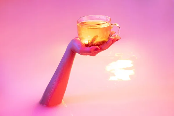 Close up female hand gesturing from the milk bath with soft glowing in neon light