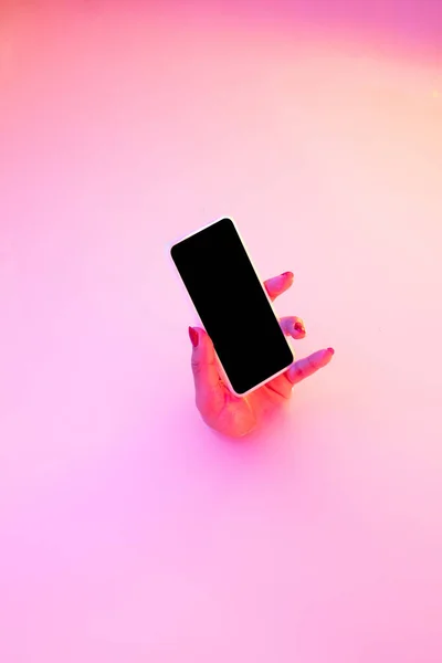 Close up female hand gesturing from the milk bath with soft glowing in neon light