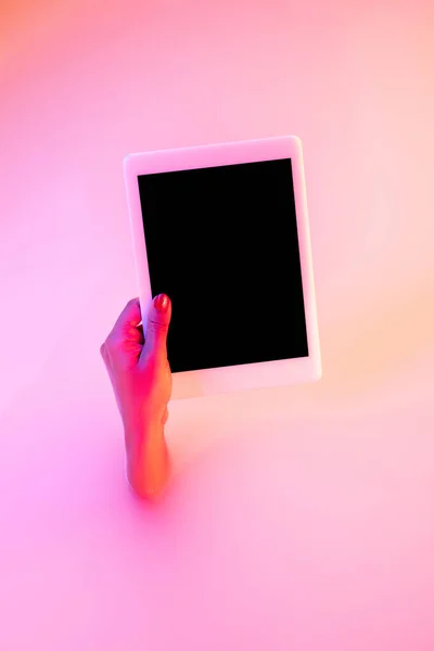 Close up female hand gesturing from the milk bath with soft glowing in neon light