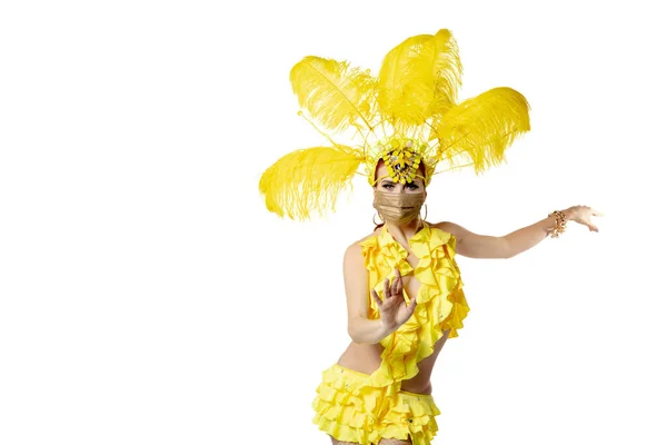 Krásná mladá žena v karnevalu, stylový maškarní kostým s peřím tančí na bílém pozadí studia. — Stock fotografie