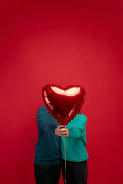 Beautiful couple in love on red studio background. Valentines Day, love and emotions concept — Stock Photo, Image