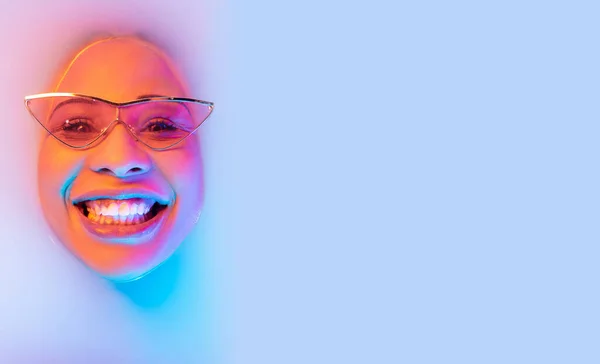 Beautiful female face in the milk bath with soft glowing in blue-pink neon light — Stock Photo, Image