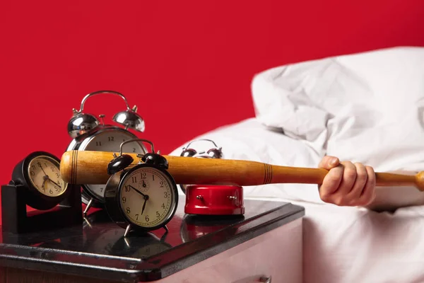 Man wakes up and hes mad at clock ringing, switches it off with baseball bat
