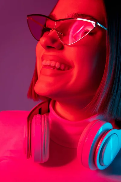 彩色霓虹灯下粉色画室背景下的高加索女性肖像 — 图库照片