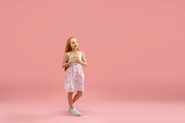 Childhood and dream about big and famous future. Pretty longhair girl isolated on coral pink background — Stock Photo, Image