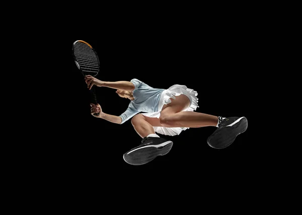 Female professional tennis player in action, motion isolated on black background, look from the bottom. Concept of sport, movement, energy and dynamic. — Stock Photo, Image