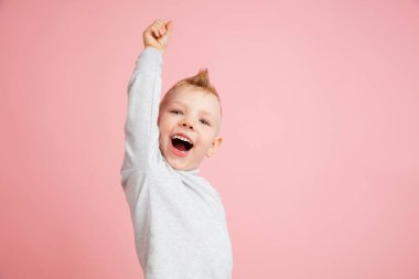 Mutlu çocuk pembe stüdyo geçmişinde izole edilmiş. Mutlu, neşeli ve samimi görünüyor. Kopyalama. Çocukluk, eğitim, duygu kavramı