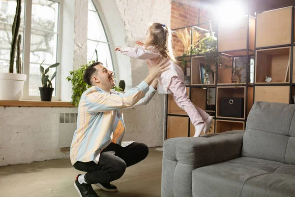 Gelukkige vader en kleine schattige dochter thuis. Familie tijd, gehamer, ouderschap en gelukkige kindertijd concept. Weekend met oprechte emoties. — Stockfoto