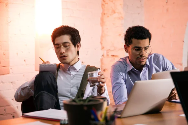 Colleagues working together in modern office using devices and gadgets during creative meeting — Stock Photo, Image