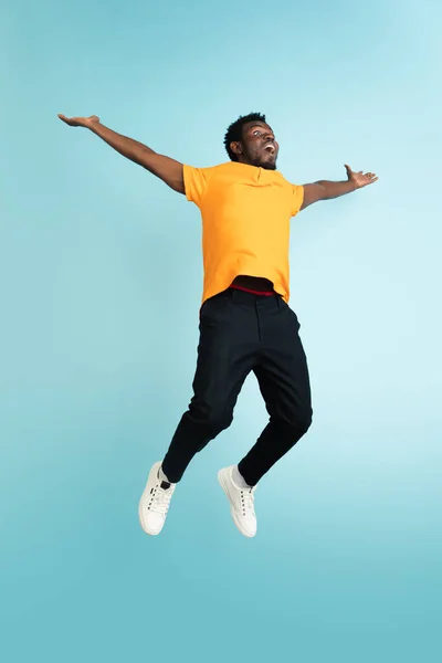 Retrato de comprimento total de jovem africano isolado sobre fundo estúdio azul com copyspace — Fotografia de Stock