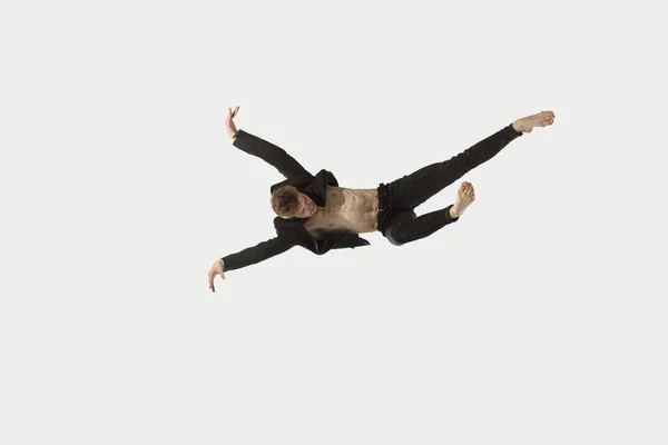 Man in casual style clothes jumping and dancing isolated on white background. Art, motion, action, flexibility, inspiration concept. Flexible caucasian ballet dancer. — Stock Photo, Image