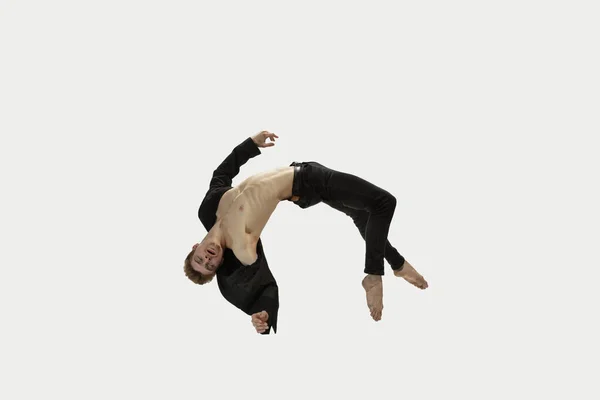 Man in casual style clothes jumping and dancing isolated on white background. Art, motion, action, flexibility, inspiration concept. Flexible caucasian ballet dancer. — Stock Photo, Image