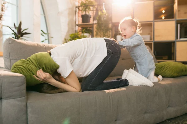 Familietid. Mor og datter som får være sammen hjemme, ser lykkelige og oppriktige ut – stockfoto