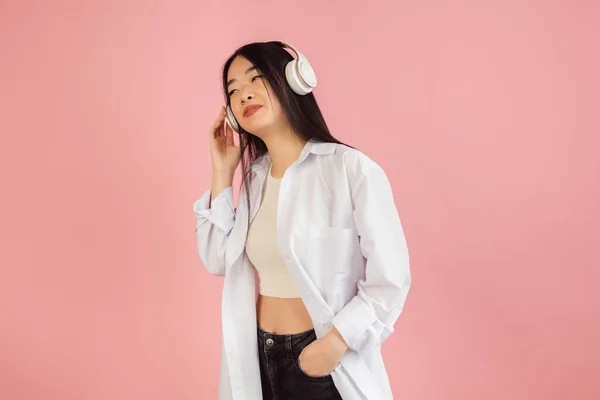 Aziatische jonge vrouwen portret op roze studio achtergrond. Concept van menselijke emoties, gezichtsuitdrukking, jeugd, verkoop, reclame. — Stockfoto