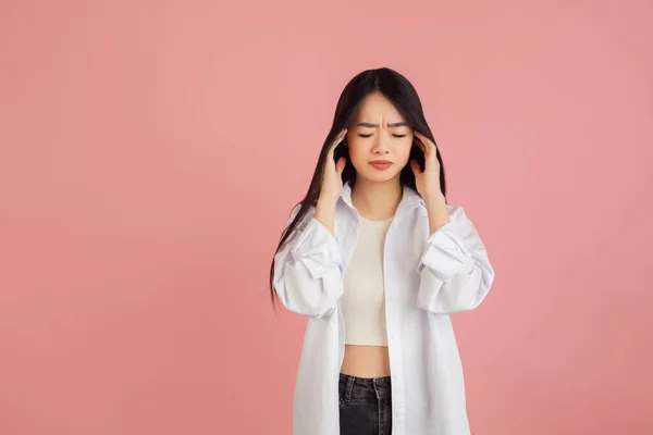 在粉红工作室背景上的亚洲年轻女性肖像。人类情感、面部表情、青春、销售、广告的概念. — 图库照片