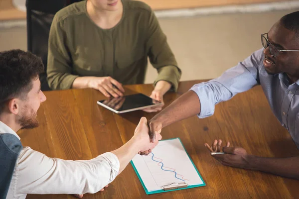 Colleagues working together in modern office using devices and gadgets during negotiations — Stock Photo, Image