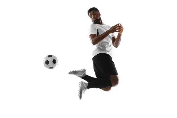 Young African football soccer player training isolated on white background. Concept of sport, movement, energy and dynamic. — Stock Photo, Image