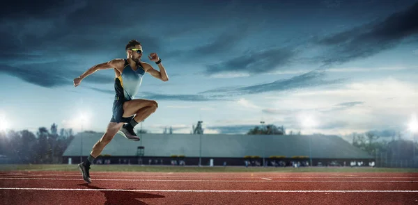 Professional male runner, jogger on stadium background. Caucasian fit athlete practicing, training excited — Stock Photo, Image