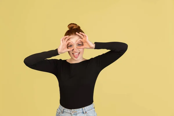 Portrait of Caucasian happy young girl isolated over yellow studio background with copyspace for ad. Concept of beauty, health. — Stock fotografie