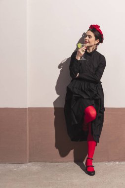 Full length portrait of young woman in image of famous artist, person isolated over white brown background with shadow.