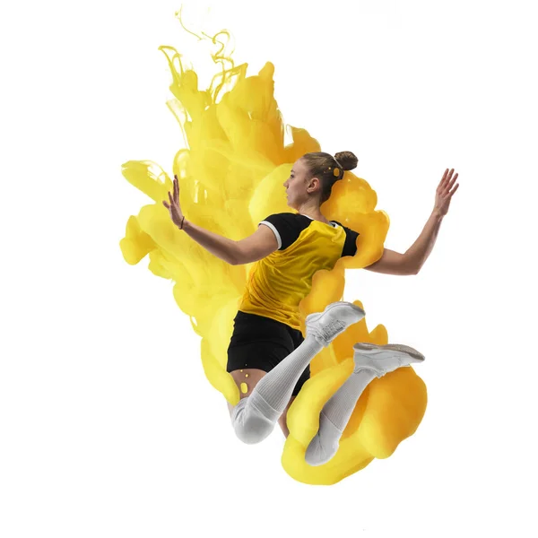 Young girl volleyball player in explosion of yellow colored neon luiquid fluid isolated on white background. — 图库照片